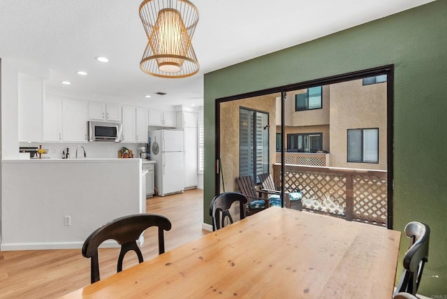 dining area featuring light wood-type flooring