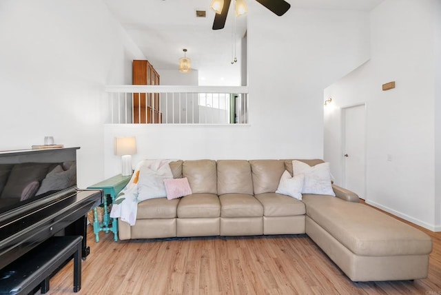 living room featuring light hardwood / wood-style flooring and ceiling fan