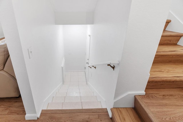 stairway with tile patterned floors