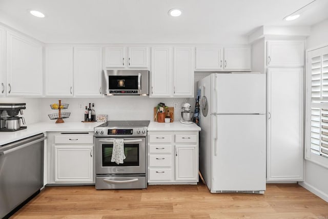 kitchen featuring light hardwood / wood-style floors, white cabinetry, and appliances with stainless steel finishes