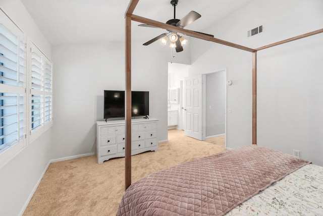 carpeted bedroom with connected bathroom, ceiling fan, and high vaulted ceiling