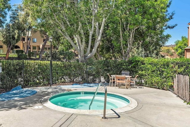 view of swimming pool with a patio area and a community hot tub