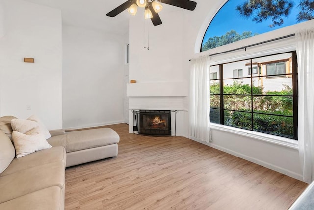 living room featuring light wood-type flooring and ceiling fan