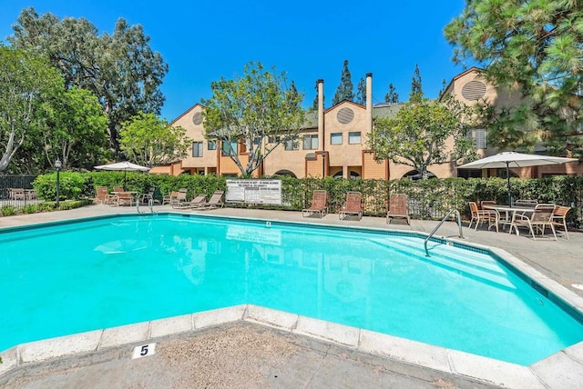 view of swimming pool with a patio