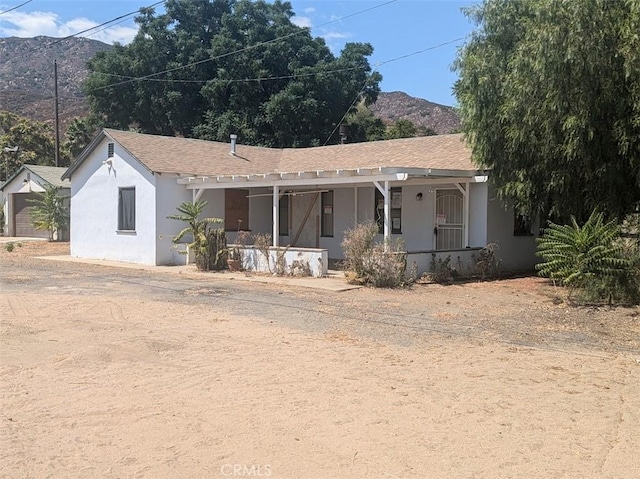 view of front facade featuring a mountain view and covered porch