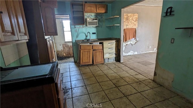 kitchen featuring sink, a wall mounted air conditioner, and light tile patterned floors