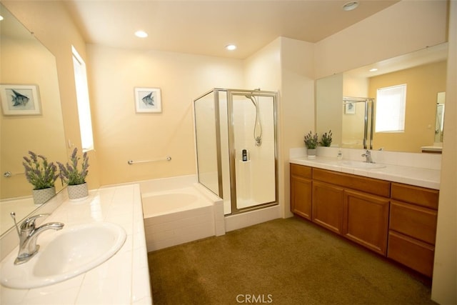 bathroom featuring independent shower and bath and vanity