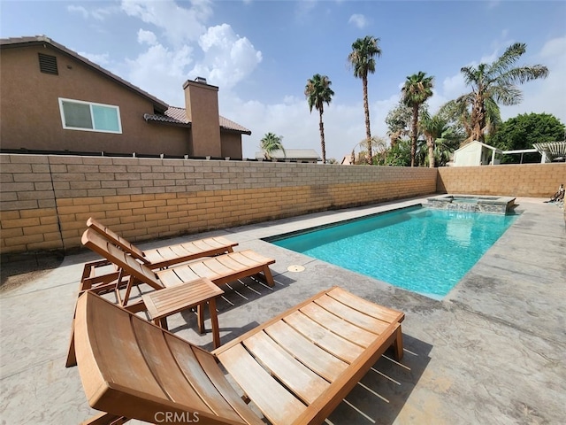 view of pool featuring an in ground hot tub and a patio