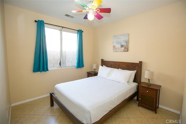 bedroom with ceiling fan and light tile patterned flooring