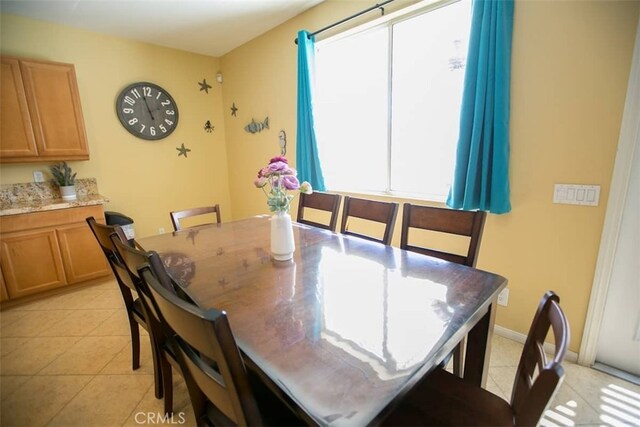 tiled dining space featuring plenty of natural light