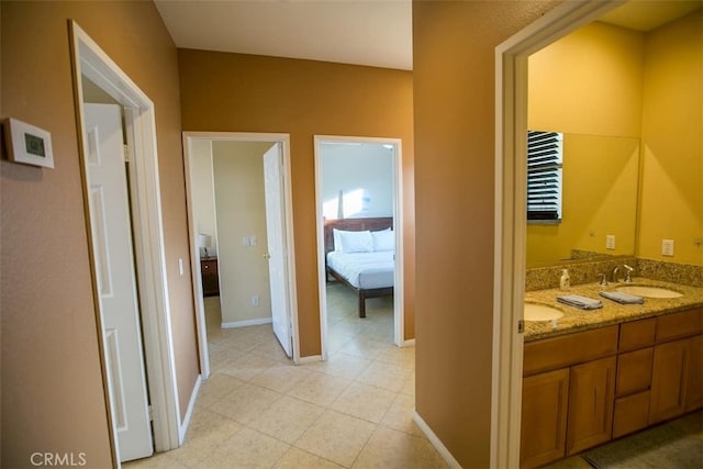 hallway with light tile patterned flooring and sink