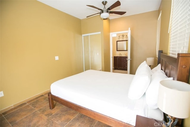 bedroom featuring ceiling fan and ensuite bath