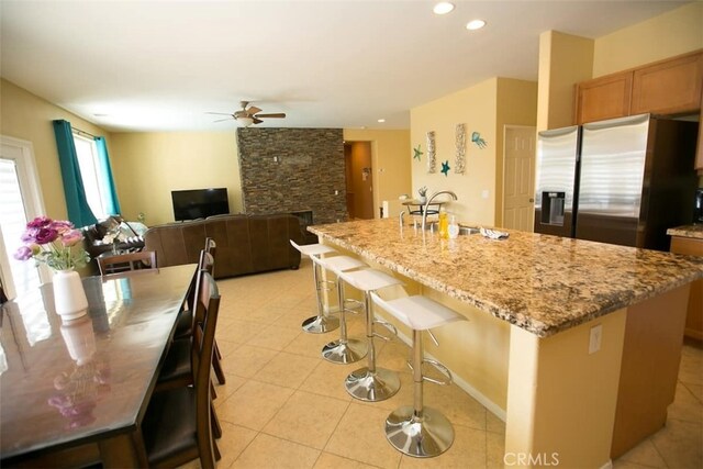 kitchen with a center island with sink and stainless steel fridge with ice dispenser