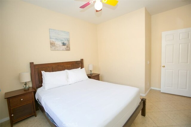 tiled bedroom featuring ceiling fan