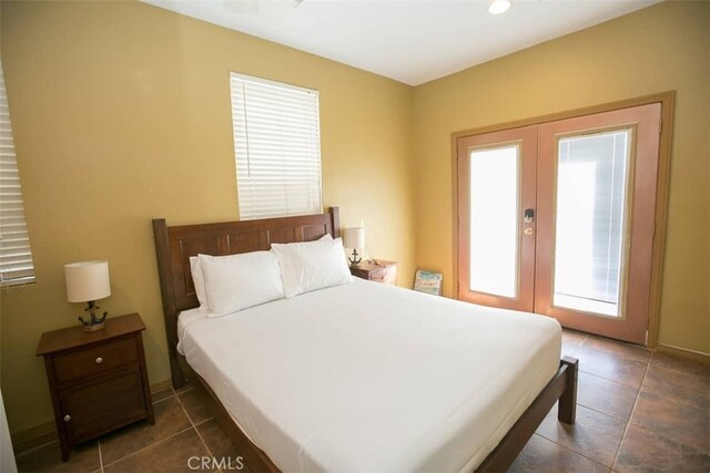 tiled bedroom featuring french doors