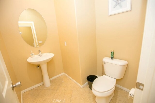 bathroom featuring toilet and tile patterned flooring