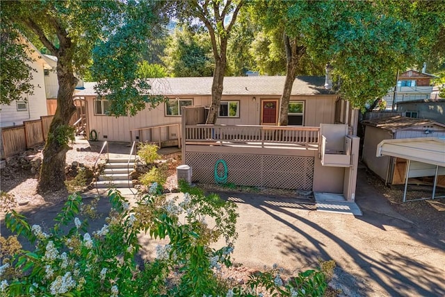 view of front of house featuring crawl space, stairs, fence, and a deck