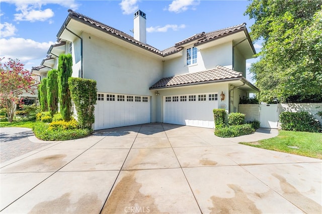 mediterranean / spanish house with a garage