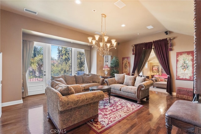 living room with vaulted ceiling, a chandelier, and dark hardwood / wood-style flooring