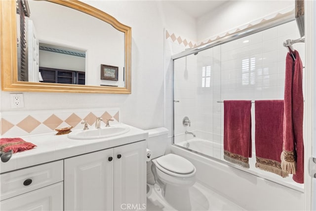 full bathroom with combined bath / shower with glass door, vanity, toilet, and tasteful backsplash