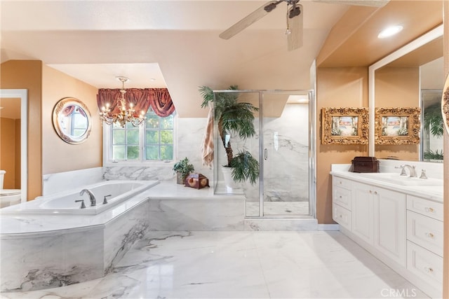 bathroom featuring ceiling fan with notable chandelier, vanity, and separate shower and tub