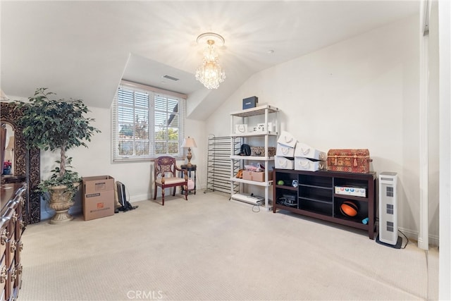 interior space featuring carpet floors, a notable chandelier, and lofted ceiling