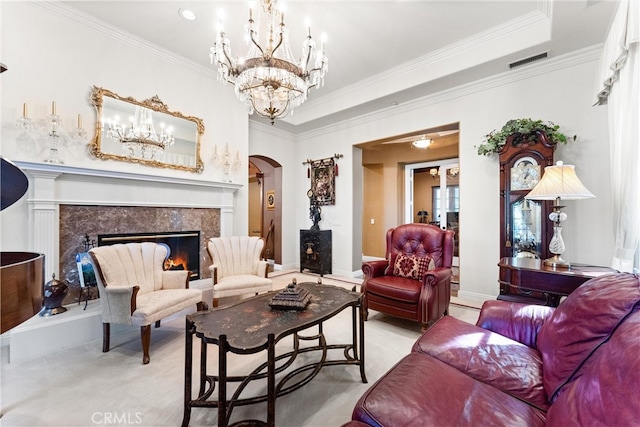 living room featuring crown molding and a high end fireplace