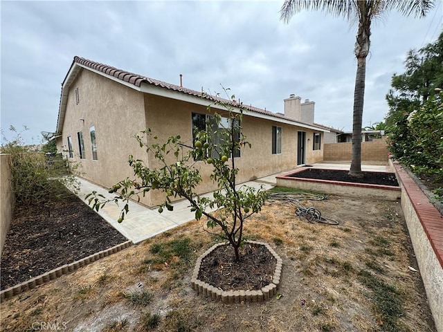 back of house with a patio area