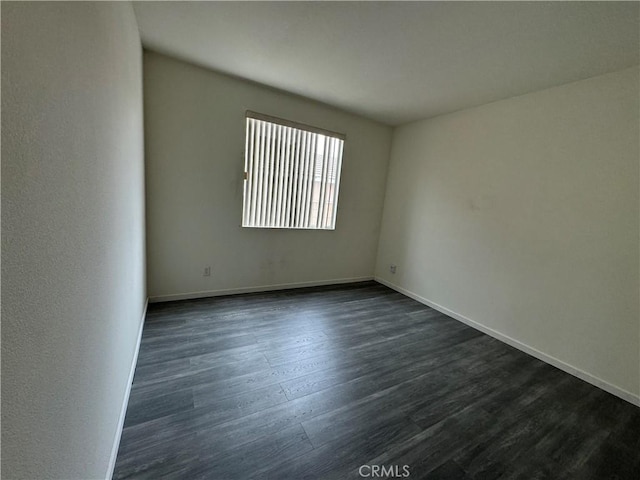 empty room featuring dark wood-type flooring