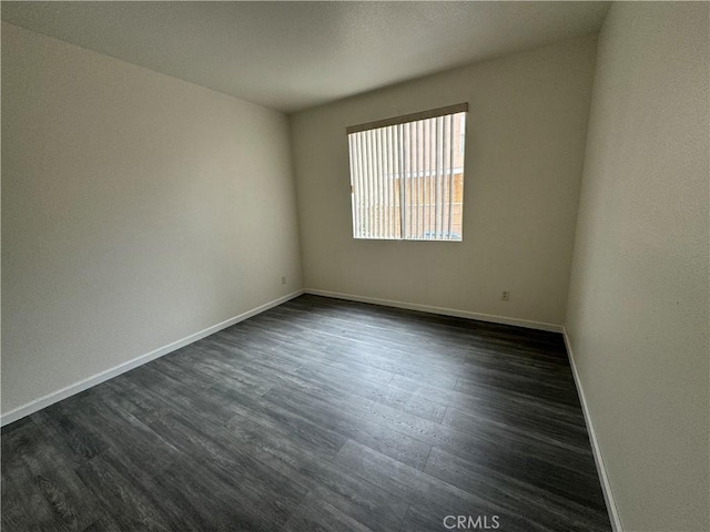 spare room featuring dark hardwood / wood-style flooring