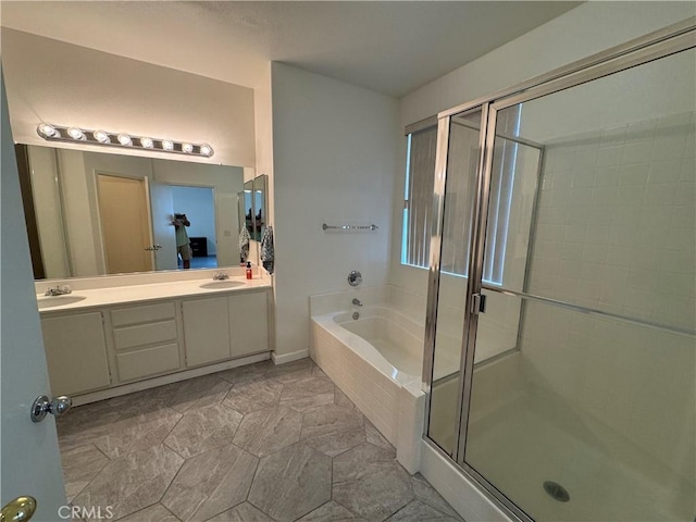 bathroom featuring shower with separate bathtub and vanity