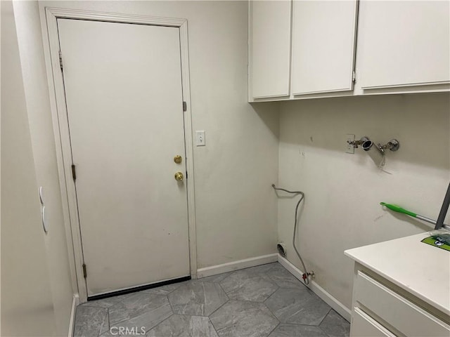 washroom with hookup for a washing machine and cabinets