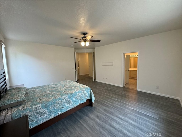 bedroom featuring a textured ceiling, ceiling fan, dark wood-type flooring, and connected bathroom