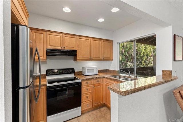 kitchen with kitchen peninsula, sink, white appliances, light tile patterned flooring, and light stone countertops