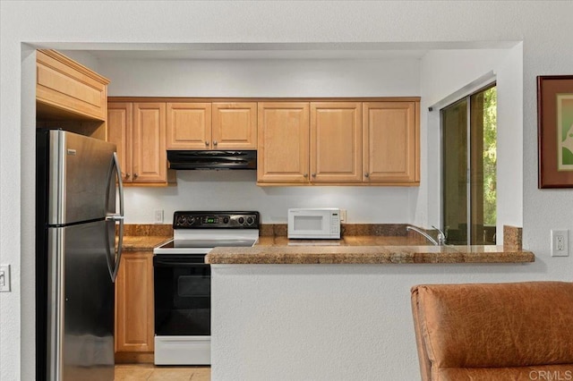 kitchen featuring sink, white appliances, light tile patterned floors, and stone counters