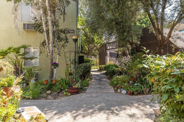 view of property's community featuring a storage shed and a patio