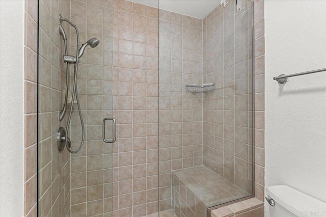 bathroom with toilet and walk in shower