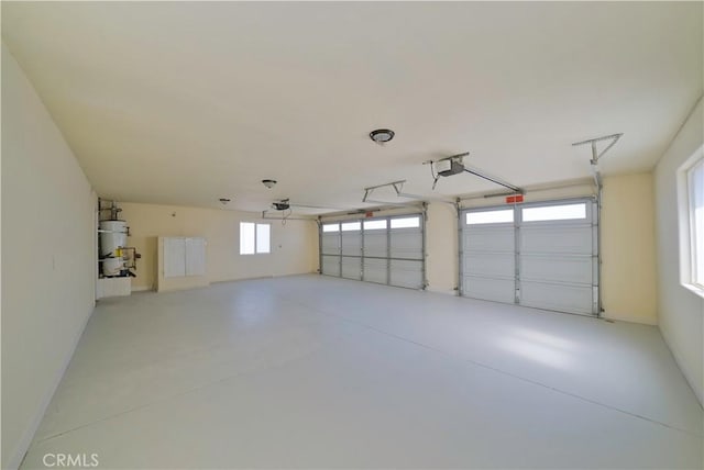 garage with secured water heater and a garage door opener