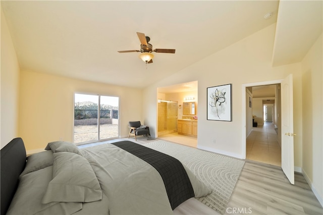 bedroom featuring ceiling fan, light hardwood / wood-style floors, connected bathroom, and vaulted ceiling