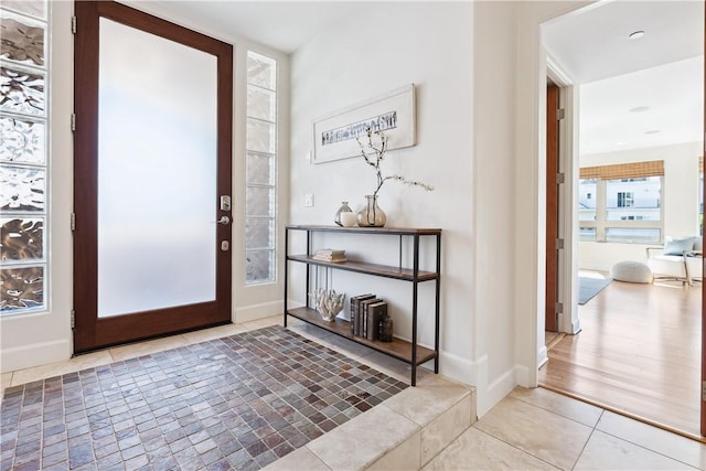 foyer entrance with light hardwood / wood-style floors