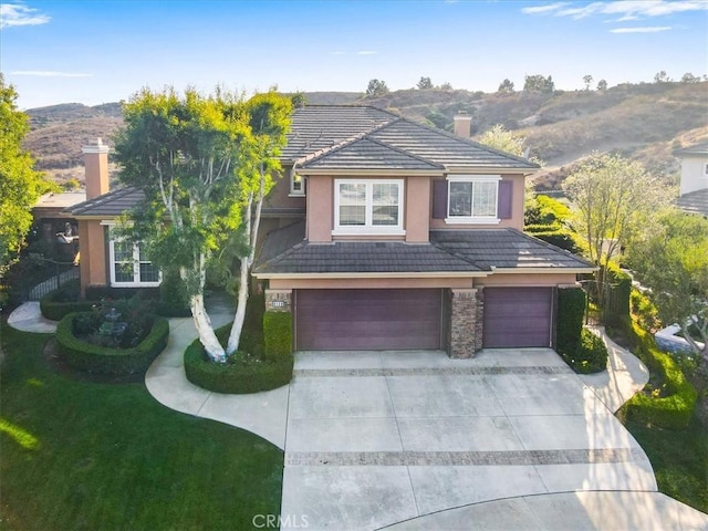 view of front of home with a front yard and a garage