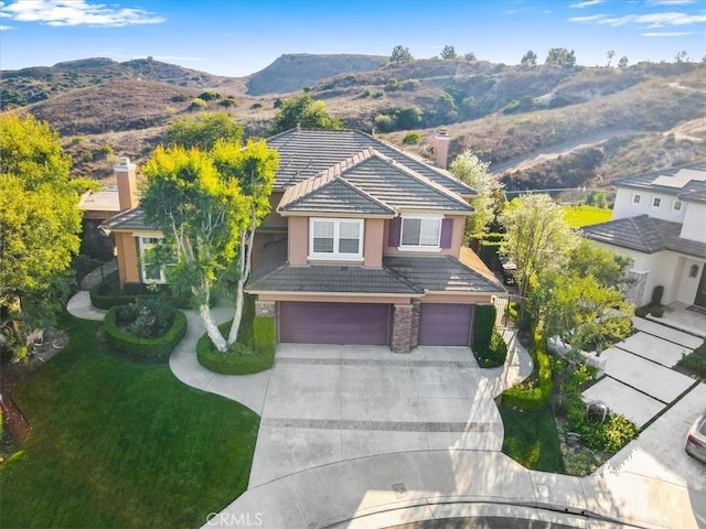 birds eye view of property featuring a mountain view