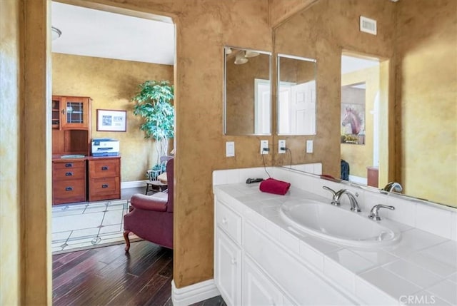 bathroom with vanity and hardwood / wood-style flooring