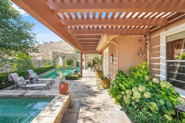 view of patio featuring a pergola and a fenced in pool