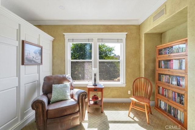 living area with carpet floors and crown molding