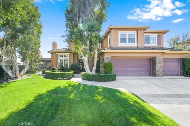 view of front of home with a front yard and a garage