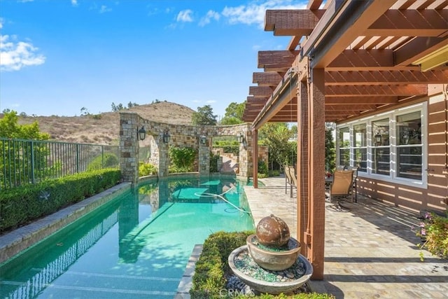 view of pool with a mountain view, a pergola, and a patio