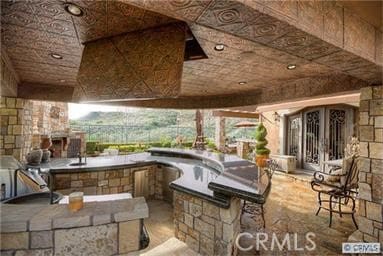 view of patio / terrace featuring a gazebo and an outdoor kitchen