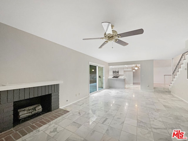 unfurnished living room featuring ceiling fan and a fireplace