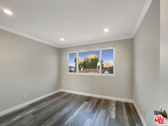 empty room with crown molding and dark hardwood / wood-style floors